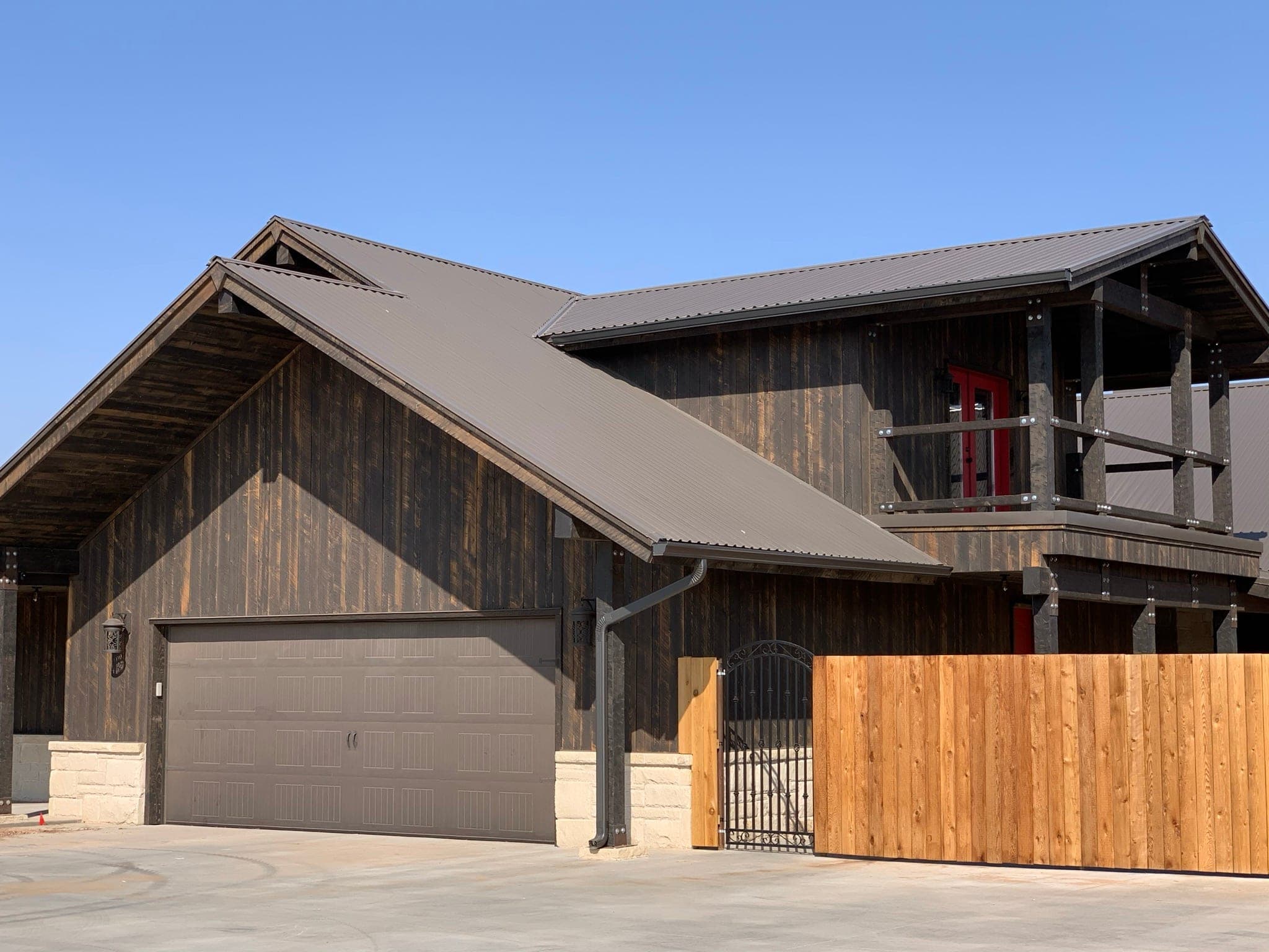 Kiker custom residence — charred vertical cedar over a stone base